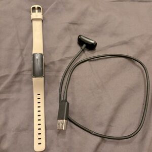 Fitbit luxe , stainless steel fitness tracker .